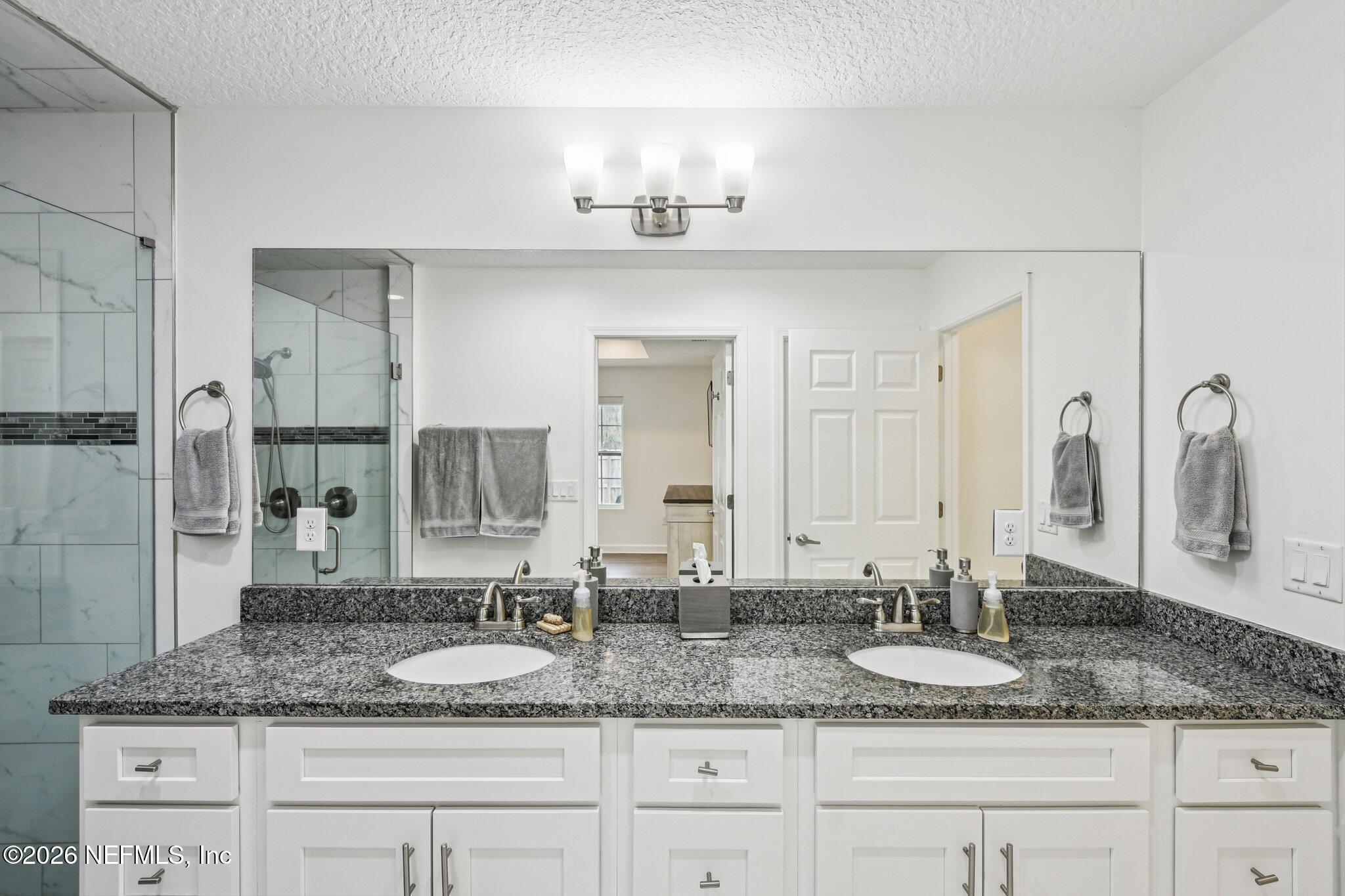 4183 Pine Road Orange Park, FL 32065 - Photo 39 of 62 a bathroom with a granite countertop sink and a mirror