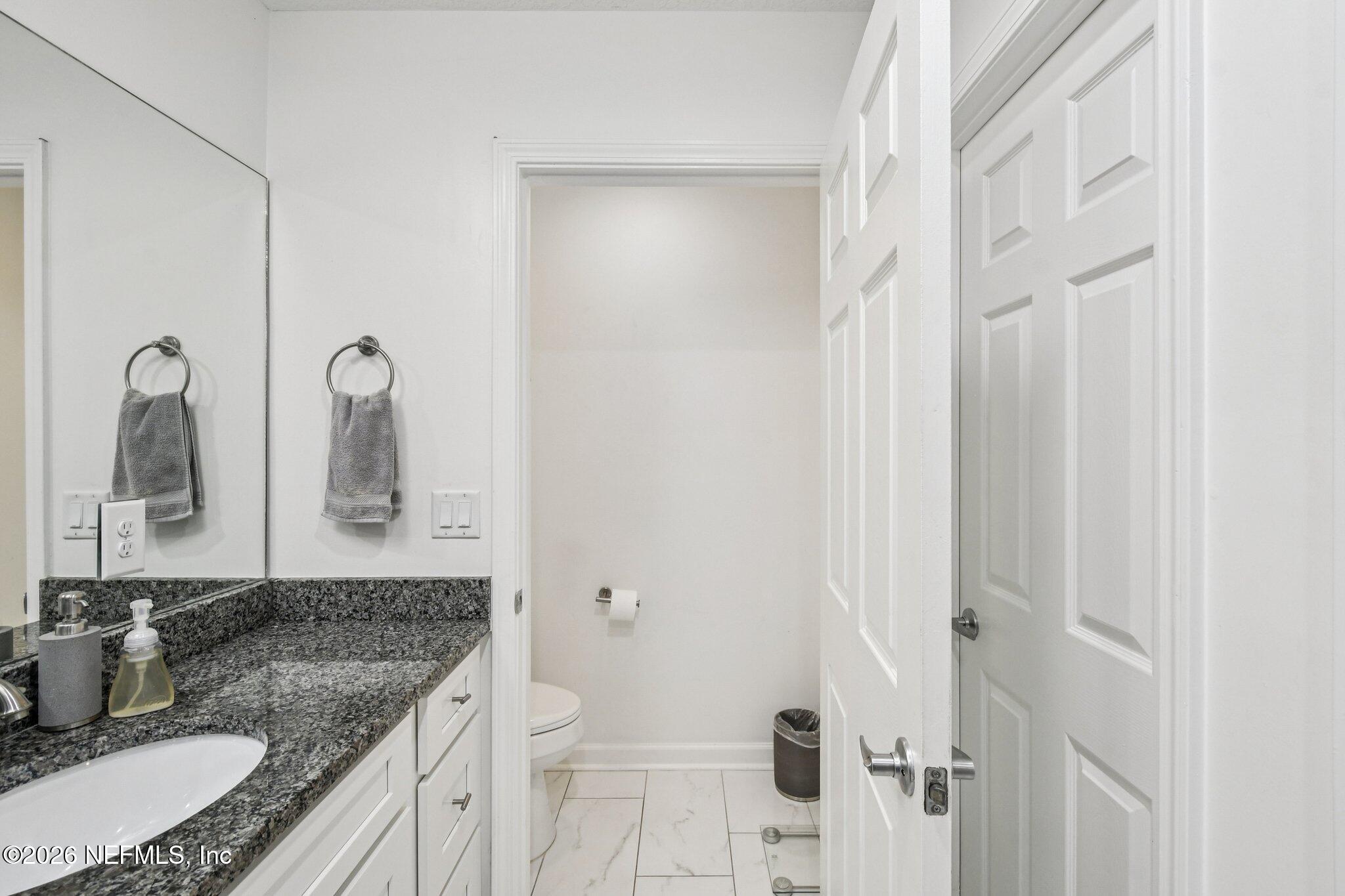 4183 Pine Road Orange Park, FL 32065 - Photo 40 of 62 a bathroom with a granite countertop sink and a mirror