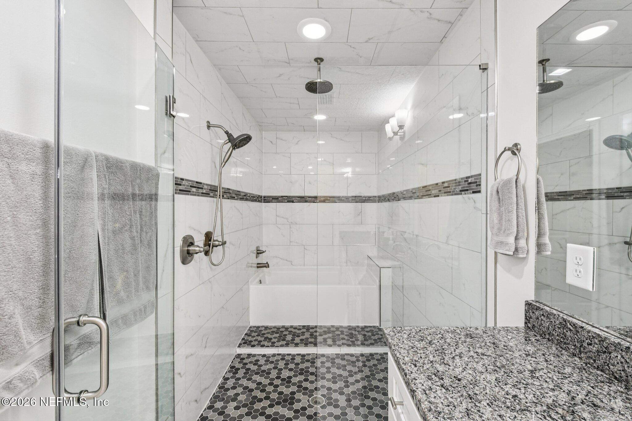 4183 Pine Road Orange Park, FL 32065 - Photo 41 of 62 a bathroom with a glass shower door