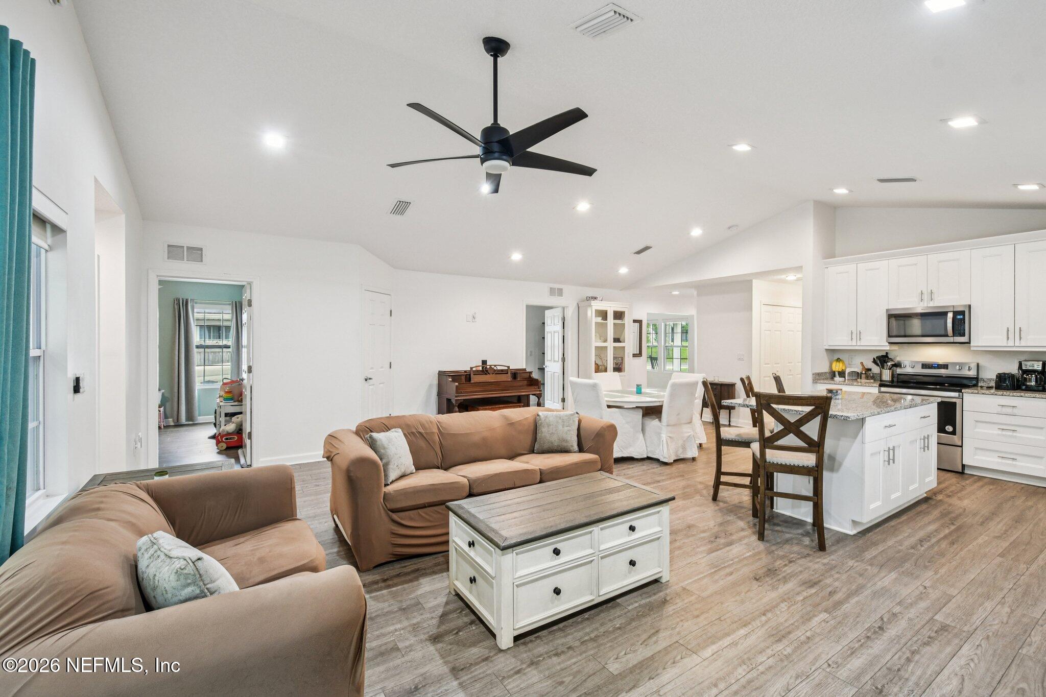 4183 Pine Road Orange Park, FL 32065 - Photo 8 of 62 a living room with furniture kitchen view and a wooden floor