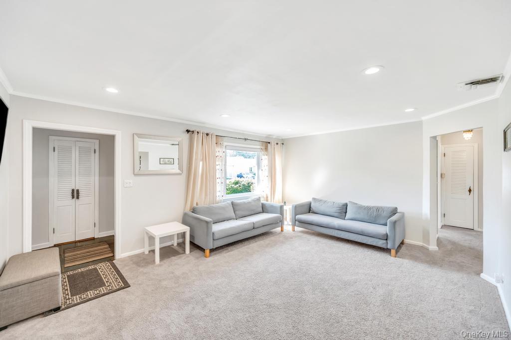 885 Downing Road Valley Stream, NY 11580 - Photo 14 of 36 Carpeted living area with ornamental molding and recessed lighting