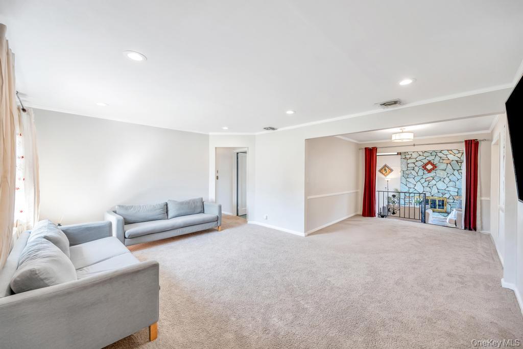 885 Downing Road Valley Stream, NY 11580 - Photo 16 of 36 Living area with light carpet and recessed lighting