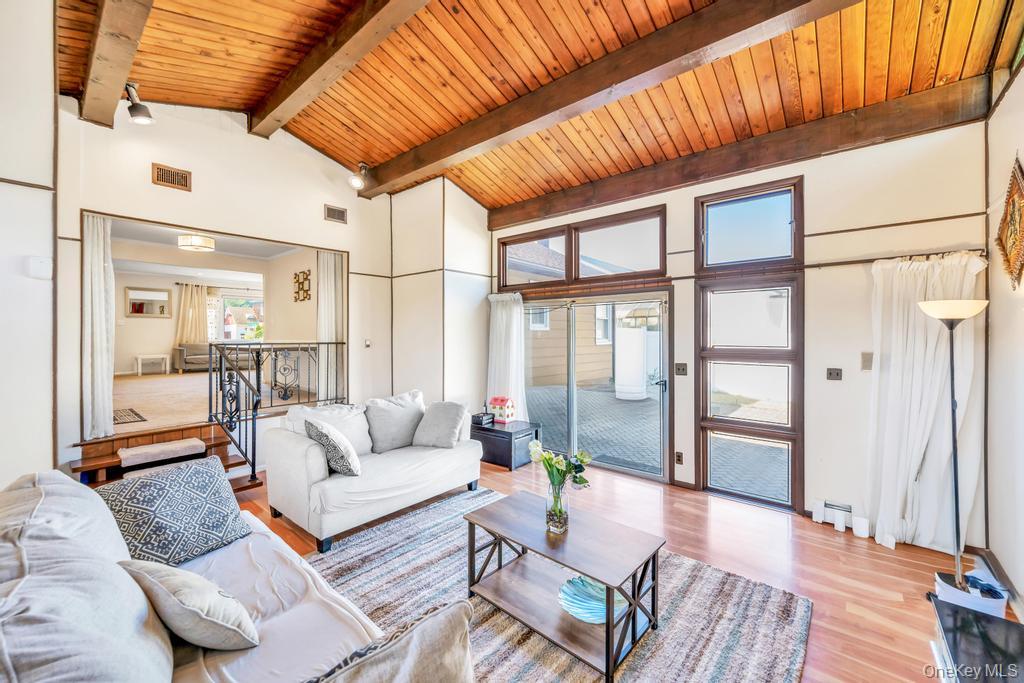 885 Downing Road Valley Stream, NY 11580 - Photo 26 of 36 Living area with light wood-style flooring, high vaulted ceiling, and a wood ceiling with exposed beams