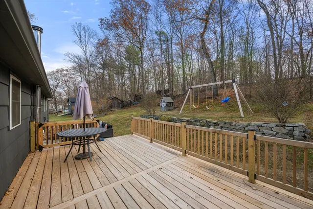 a view of a deck with chairs and wooden floor