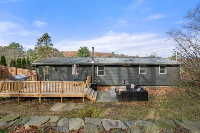 a backyard of a house with yard table and chairs