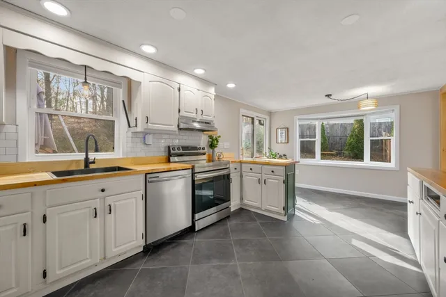 a kitchen with a sink stove and cabinets