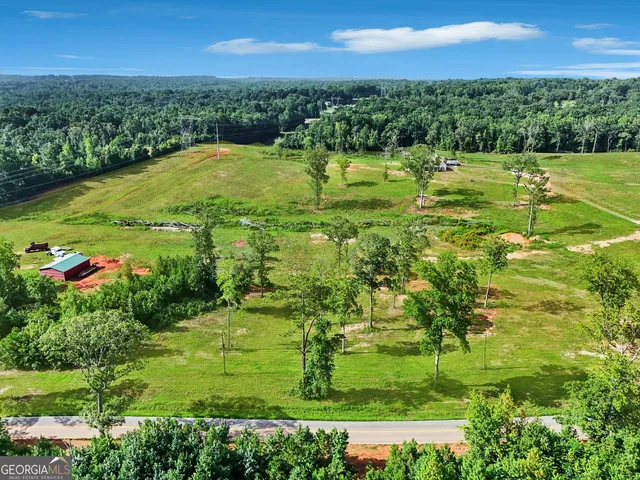 a kitchen with stainless steel appliances kitchen island granite countertop a stove a sink and a wooden floors