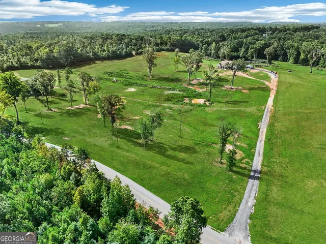 a spacious bedroom with a bed couch and a large window