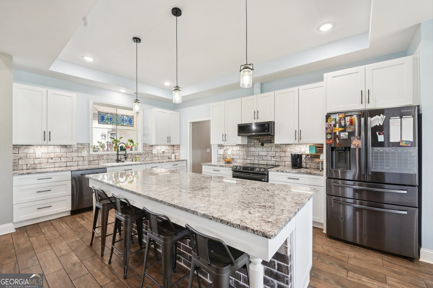 357 Old Driver Road Whitesburg, GA 30185 - Photo 2 of 75 a kitchen with kitchen island a counter space a sink appliances and cabinets