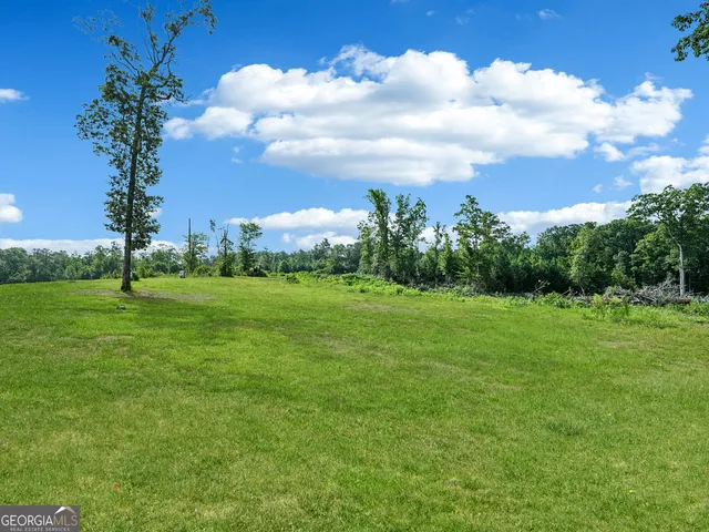 a bedroom with bed and a large window