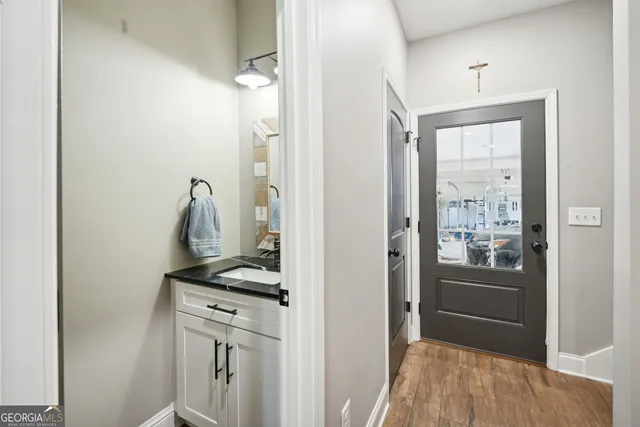 a bathroom with a sink vanity granite toilet and a mirror
