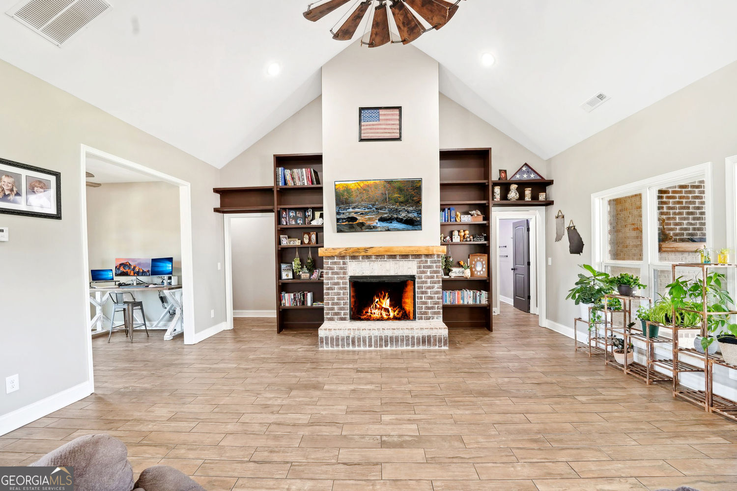 357 Old Driver Road Whitesburg, GA 30185 - Photo 32 of 75 a living room with furniture a fireplace and a flat screen tv