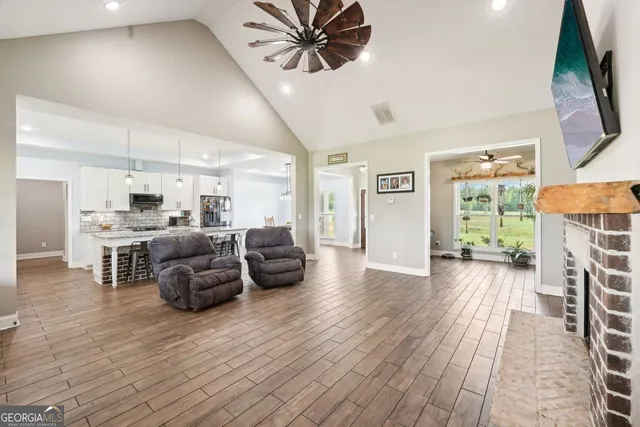 a kitchen with stainless steel appliances granite countertop a refrigerator a stove microwave and a sink