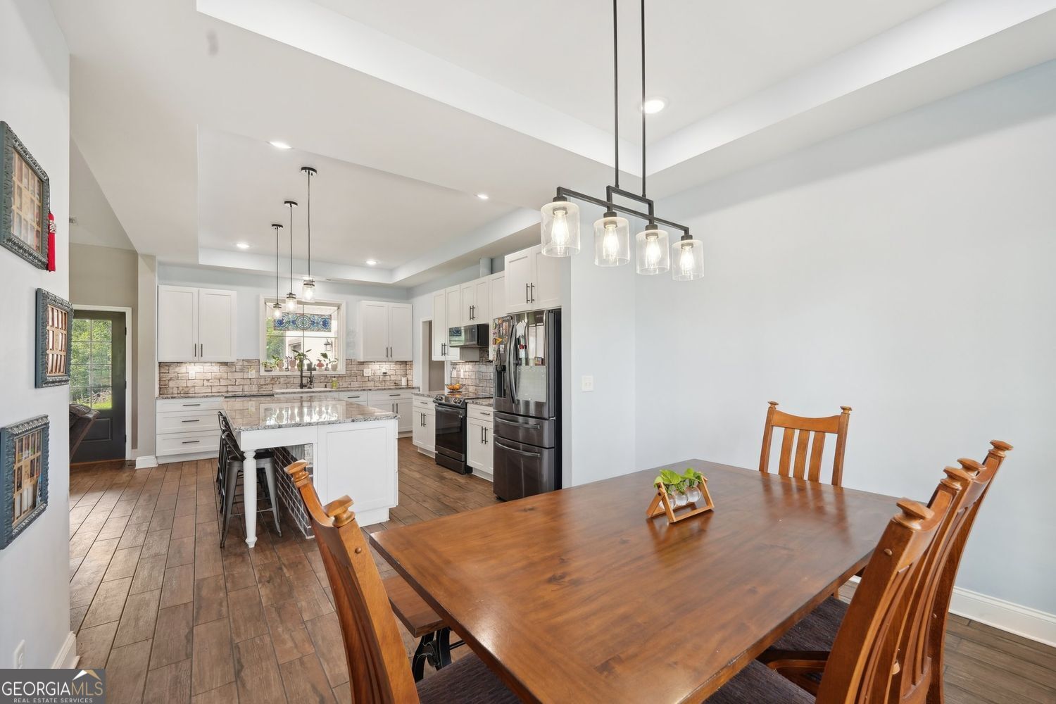 357 Old Driver Road Whitesburg, GA 30185 - Photo 40 of 75 a view of a dining room and livingroom with furniture wooden floor a chandelier
