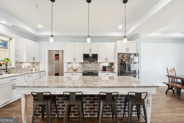 a large bathroom with a granite countertop double vanity sink a mirror and a shower