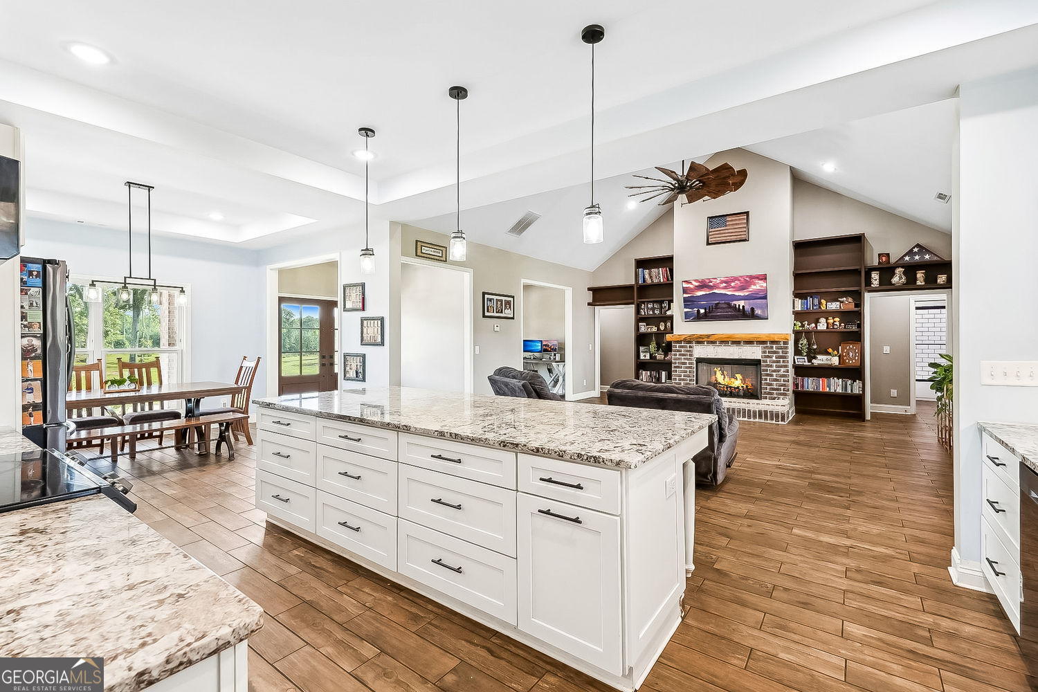 357 Old Driver Road Whitesburg, GA 30185 - Photo 46 of 75 a kitchen with stainless steel appliances kitchen island granite countertop a stove a sink and a wooden floors