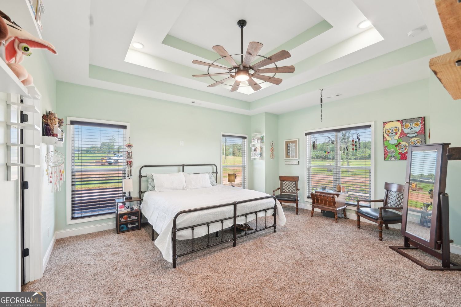 357 Old Driver Road Whitesburg, GA 30185 - Photo 47 of 75 a spacious bedroom with a bed couch and a large window