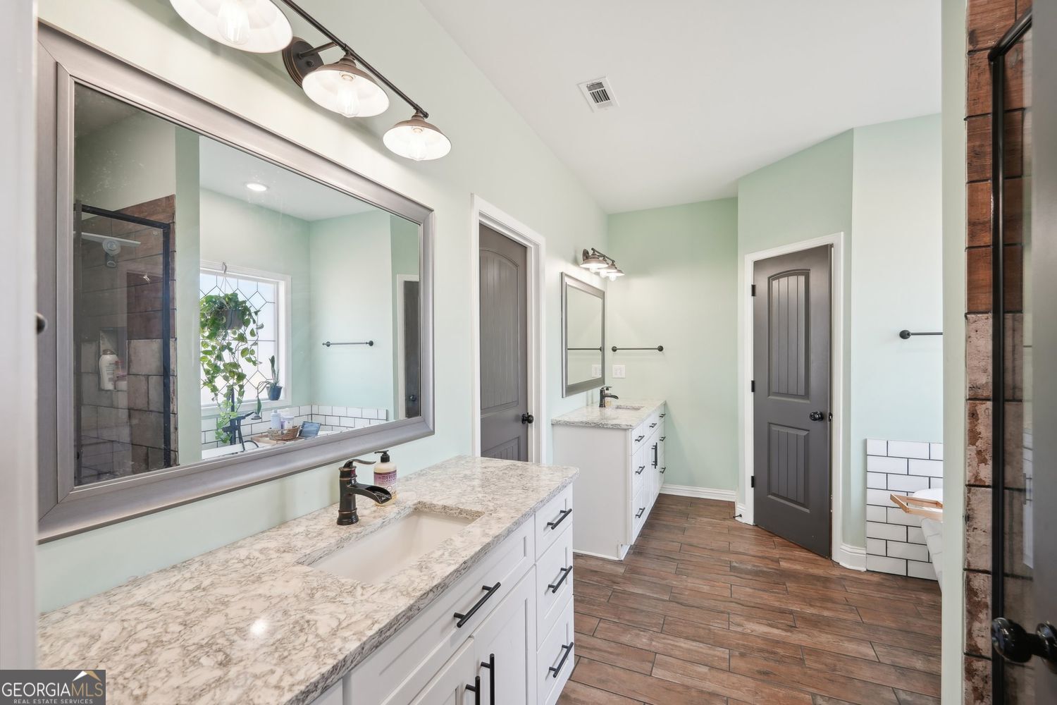 357 Old Driver Road Whitesburg, GA 30185 - Photo 51 of 75 a large bathroom with a granite countertop double vanity sink a mirror and a shower