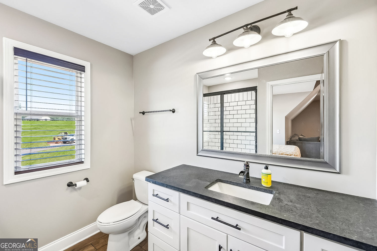 357 Old Driver Road Whitesburg, GA 30185 - Photo 69 of 75 a bathroom with a granite countertop sink mirror vanity and toilet