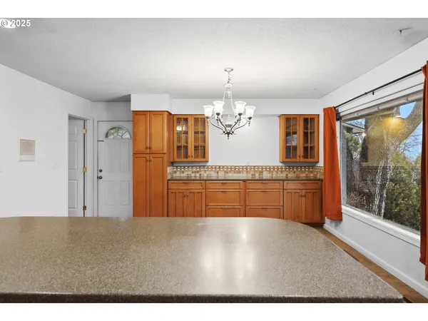 a open kitchen with granite countertop a refrigerator and a sink