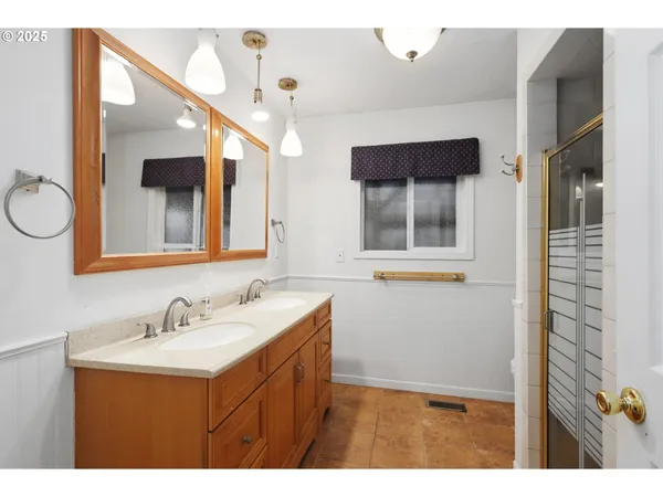 a bathroom with a sink mirror and a bathtub