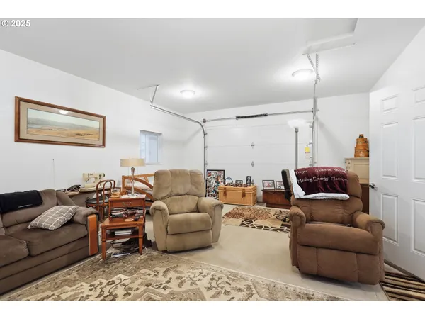 a living room with furniture a flat screen tv and a window