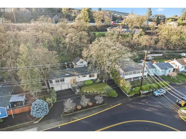 an aerial view of a house with a yard basket ball court and outdoor seating