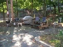 a view of a backyard with sitting area