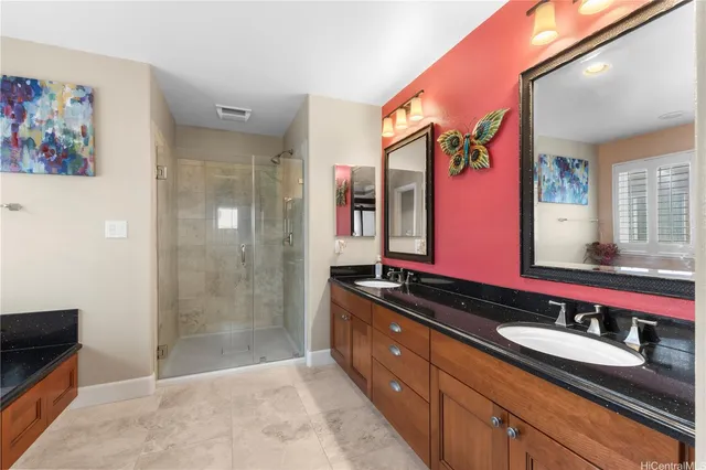 a spacious bathroom with a granite countertop sink mirror and shower