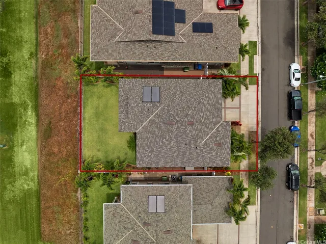 an aerial view of a house with a yard