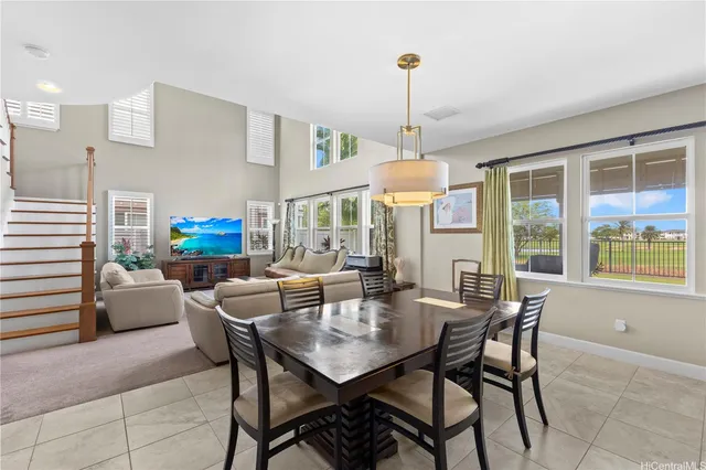 a view of a dining room with furniture a livingroom and chandelier