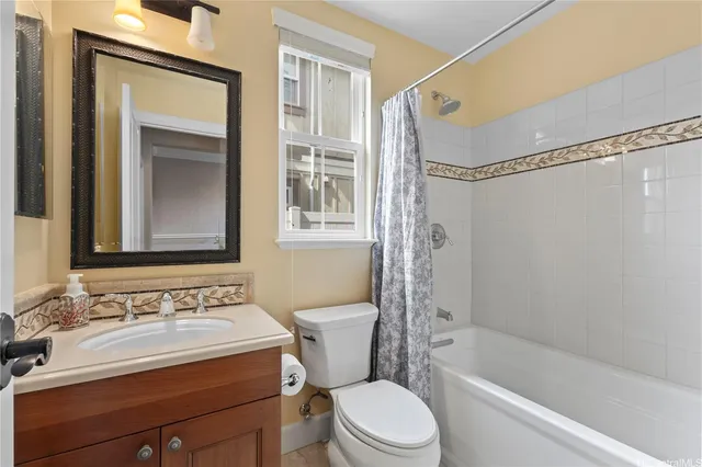 a bathroom with a sink mirror toilet and bathtub