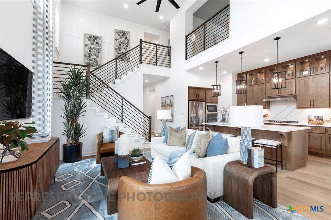 244 Basket Flower Loop Kyle, TX 78640 - Photo 13 of 34 a living room with furniture and a flat screen tv