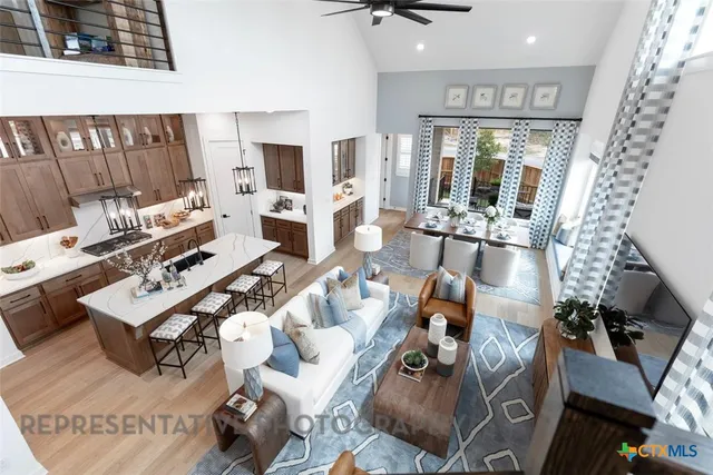 a living room with furniture and a floor to ceiling window