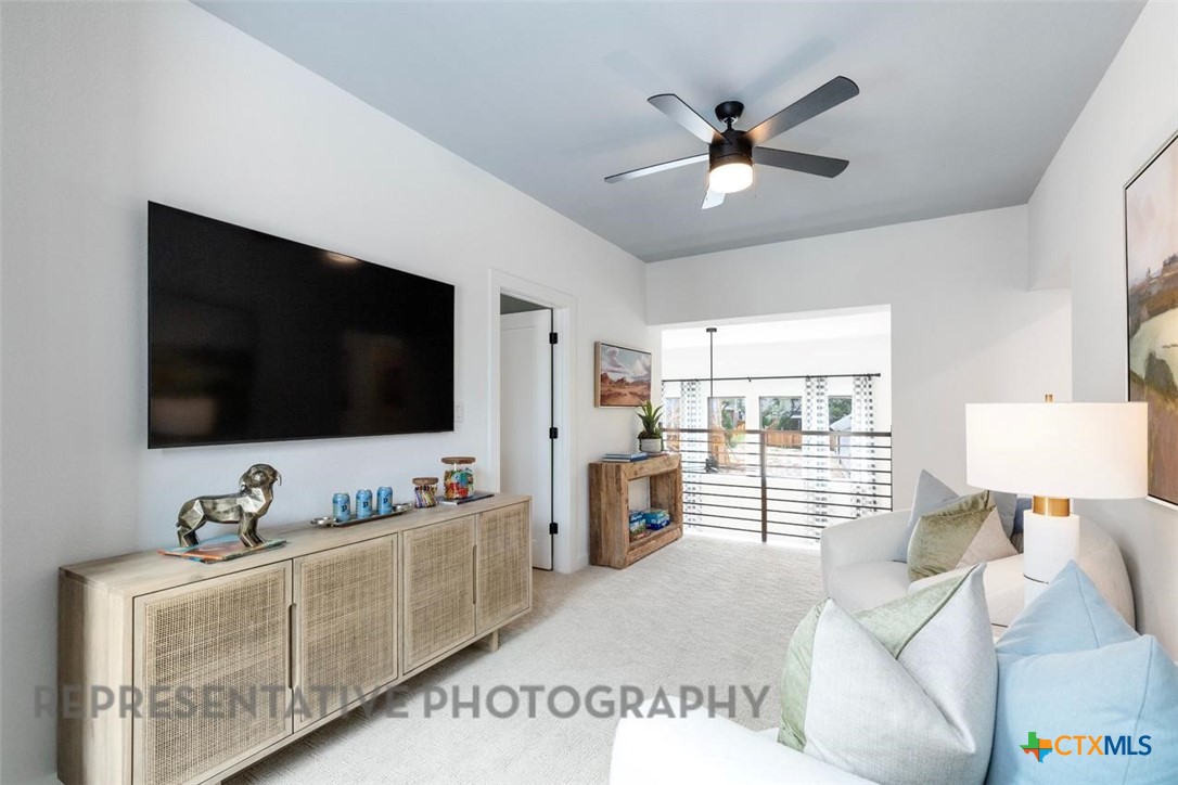 244 Basket Flower Loop Kyle, TX 78640 - Photo 16 of 34 a living room with furniture and a flat screen tv