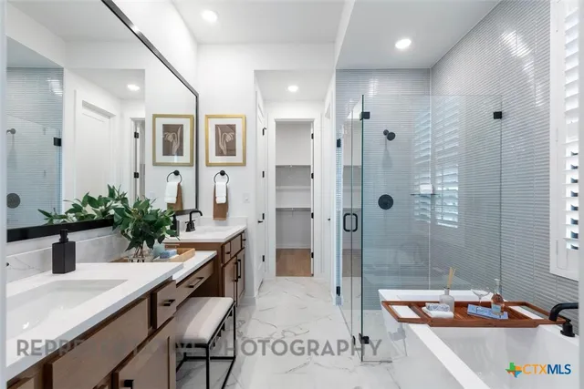 a bathroom with a tub sink and mirror