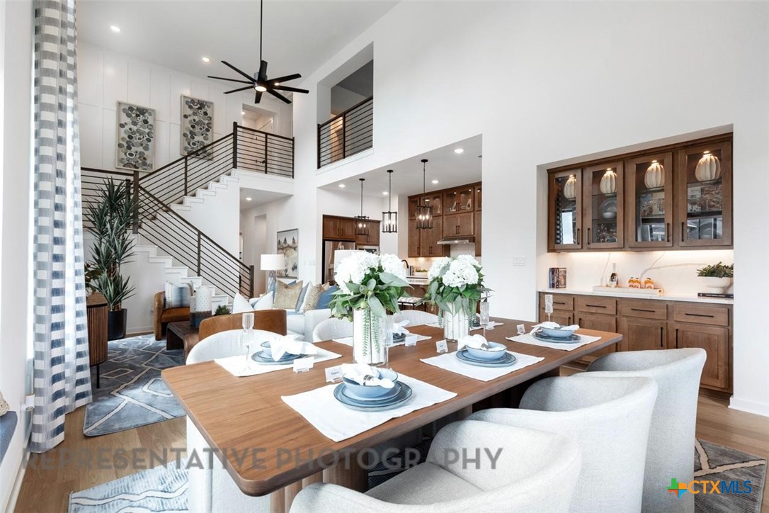 244 Basket Flower Loop Kyle, TX 78640 - Photo 10 of 34 a view of a dining room with furniture window and wooden floor