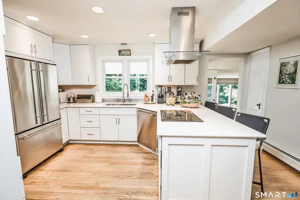a kitchen with a refrigerator a sink and cabinets