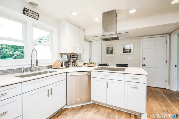 a kitchen with a sink cabinets and window
