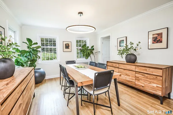 a view of a dining room with furniture and wooden floor