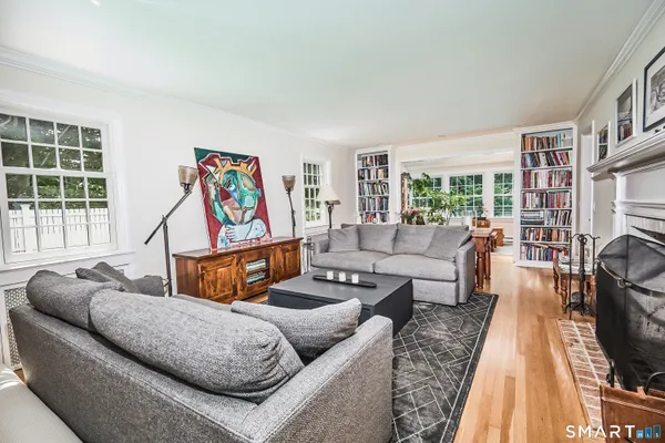 a living room with furniture a couch and a large window