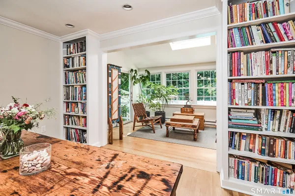 a bedroom with furniture and a book shelf