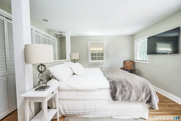 a bedroom with a bed and a flat screen tv
