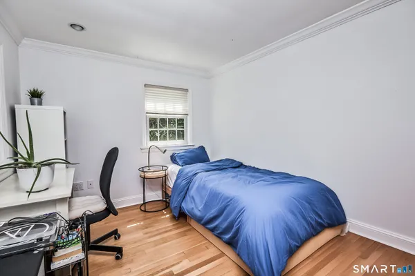 a bedroom with a bed and a chair