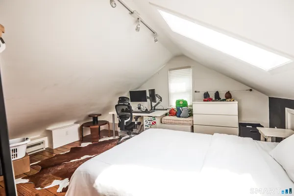 a bedroom with a bed and a tv