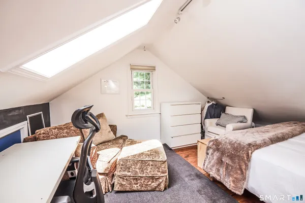 a bedroom with a bed and two windows