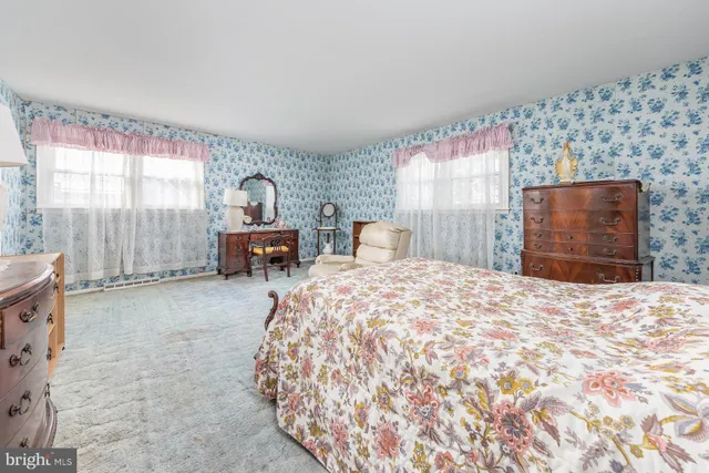 a bedroom with a bed and dresser