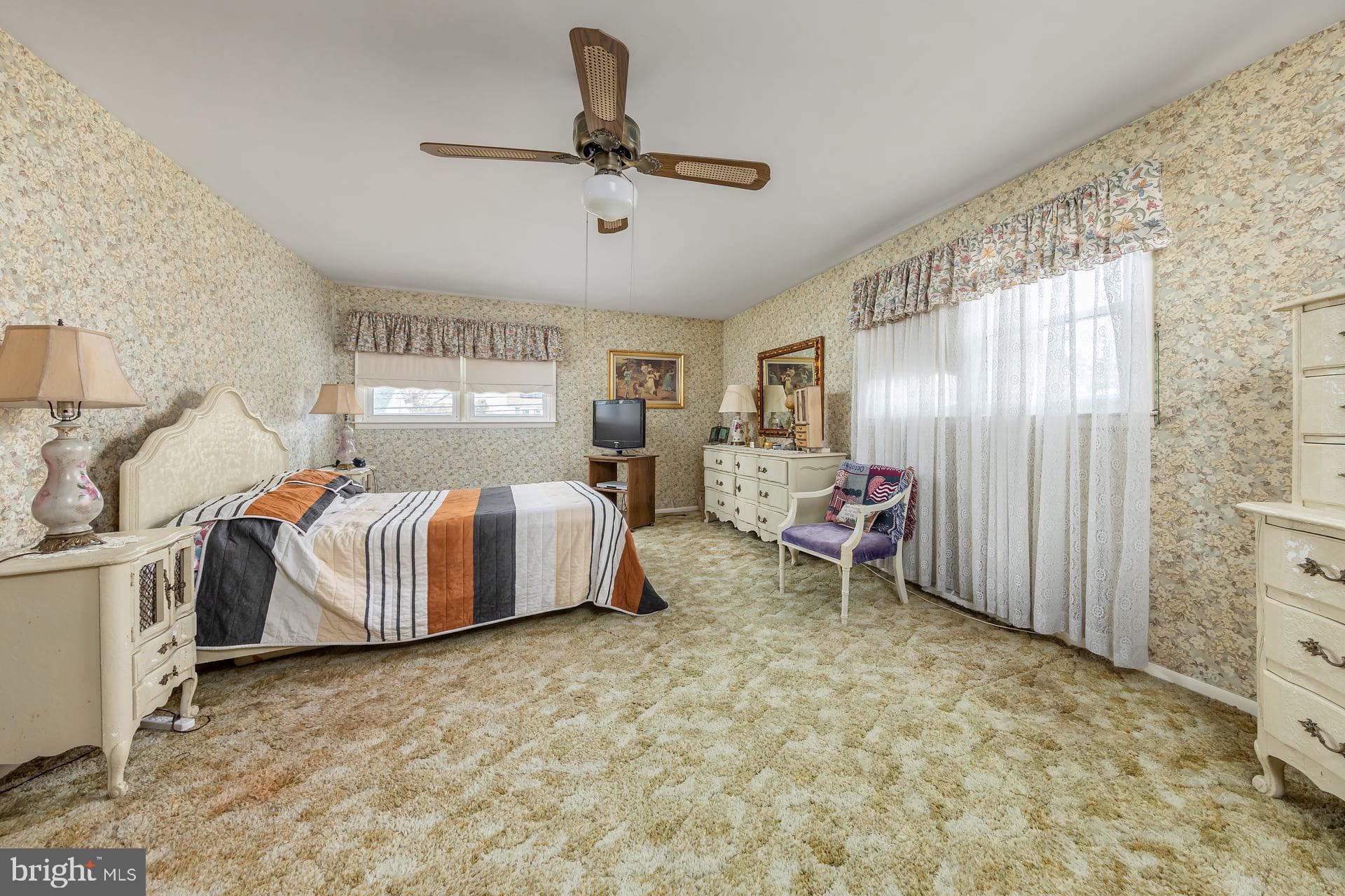 40 West Kings Highway Mount Ephraim, NJ 08059 - Photo 13 of 31 a bedroom with a bed and a chandelier