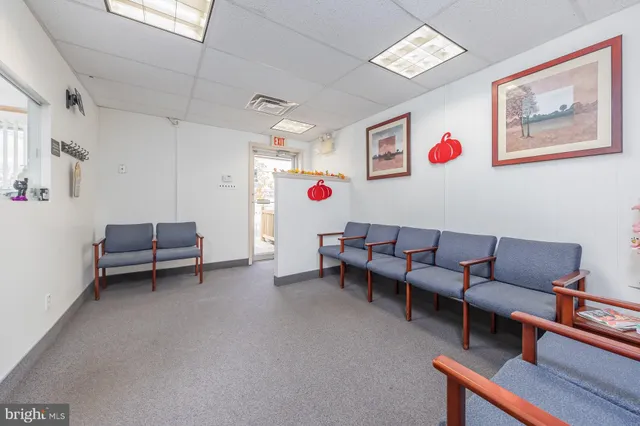 a living room with furniture and a dining table