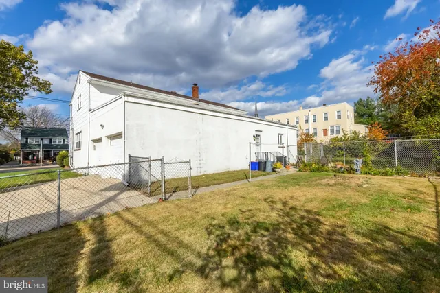 a view of a house with a big yard and large trees